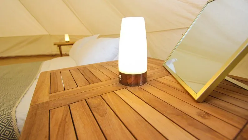 A photograph of the interior of the classic bell tent, a premium accommodation option at Lost Village.