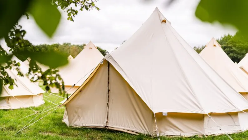 A photograph of the exterior of the classic bell tent, a premium accommodation option at Lost Village.