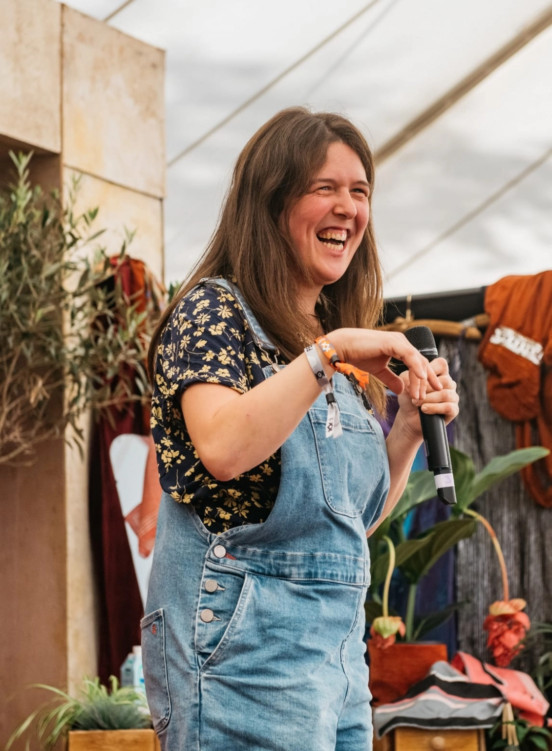 A photograph of a stand-up comedian delivering her set at Lost Village.