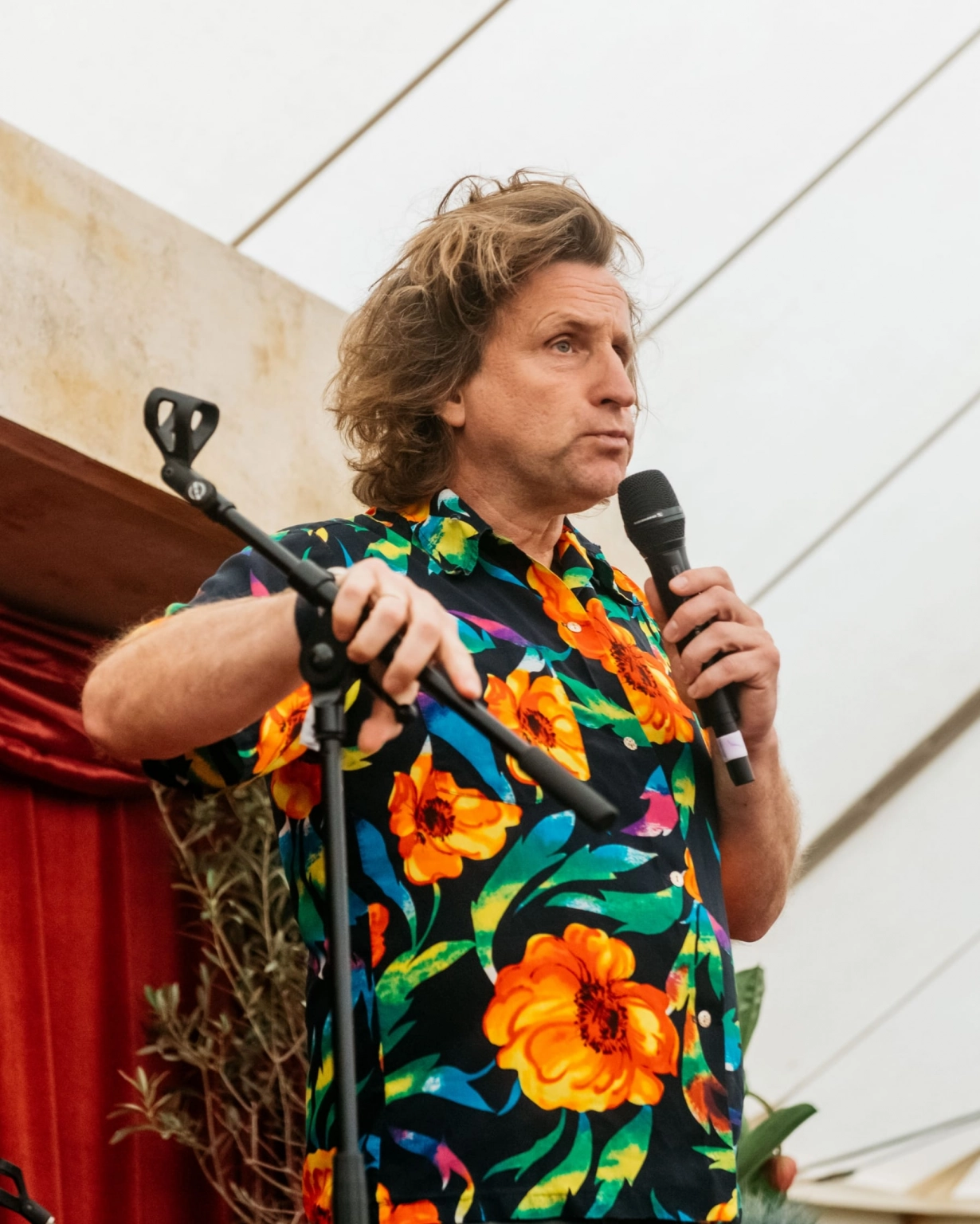 A photograph of a stand-up comedian delivering his set at Lost Village.