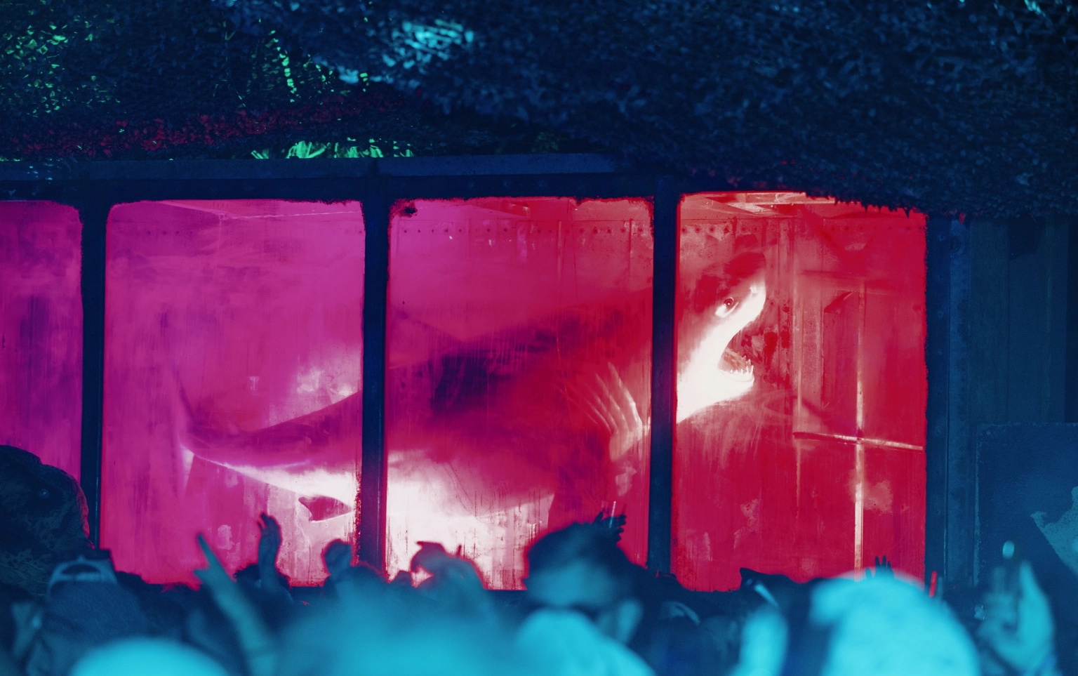A photograph of a set at Lost Village featuring a dilapidated tank with an open-mouthed shark.