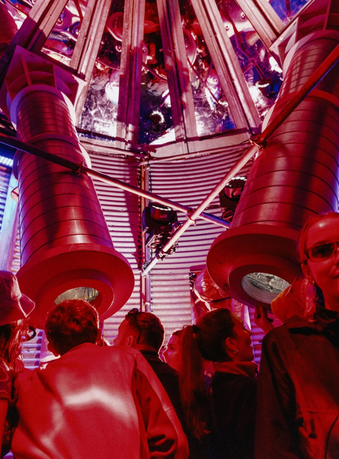 An image of people at Lost Village exploring a set with giant kaleidoscopes.