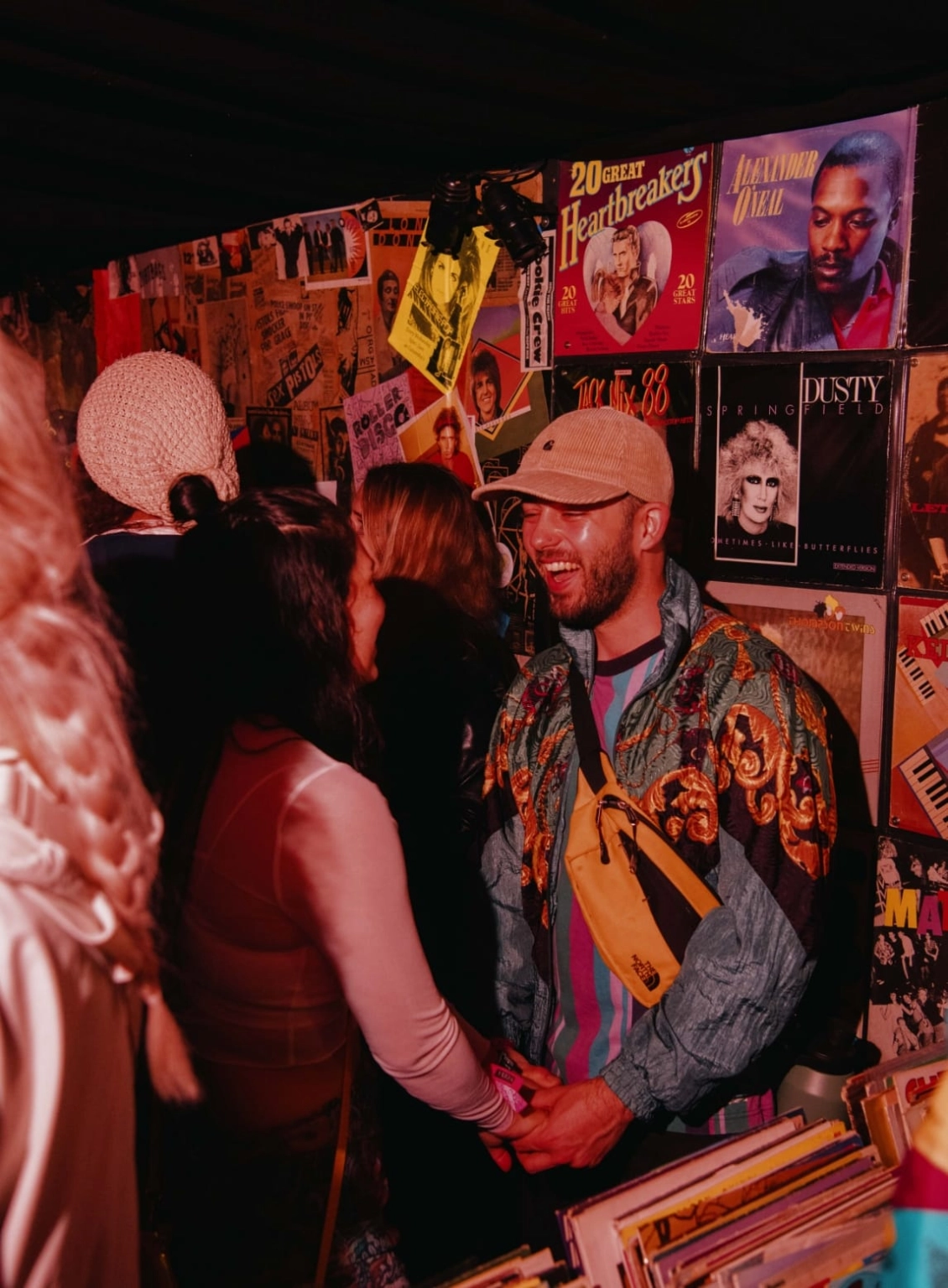 A photograph of people at Lost Village in a vintage record store set.