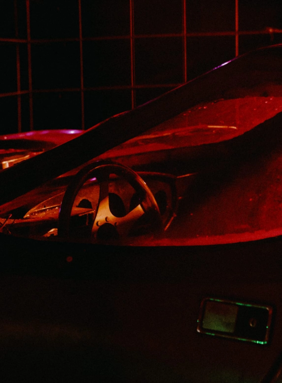 A dark cinematic photograph of an abandoned vehicle at Lost Village.