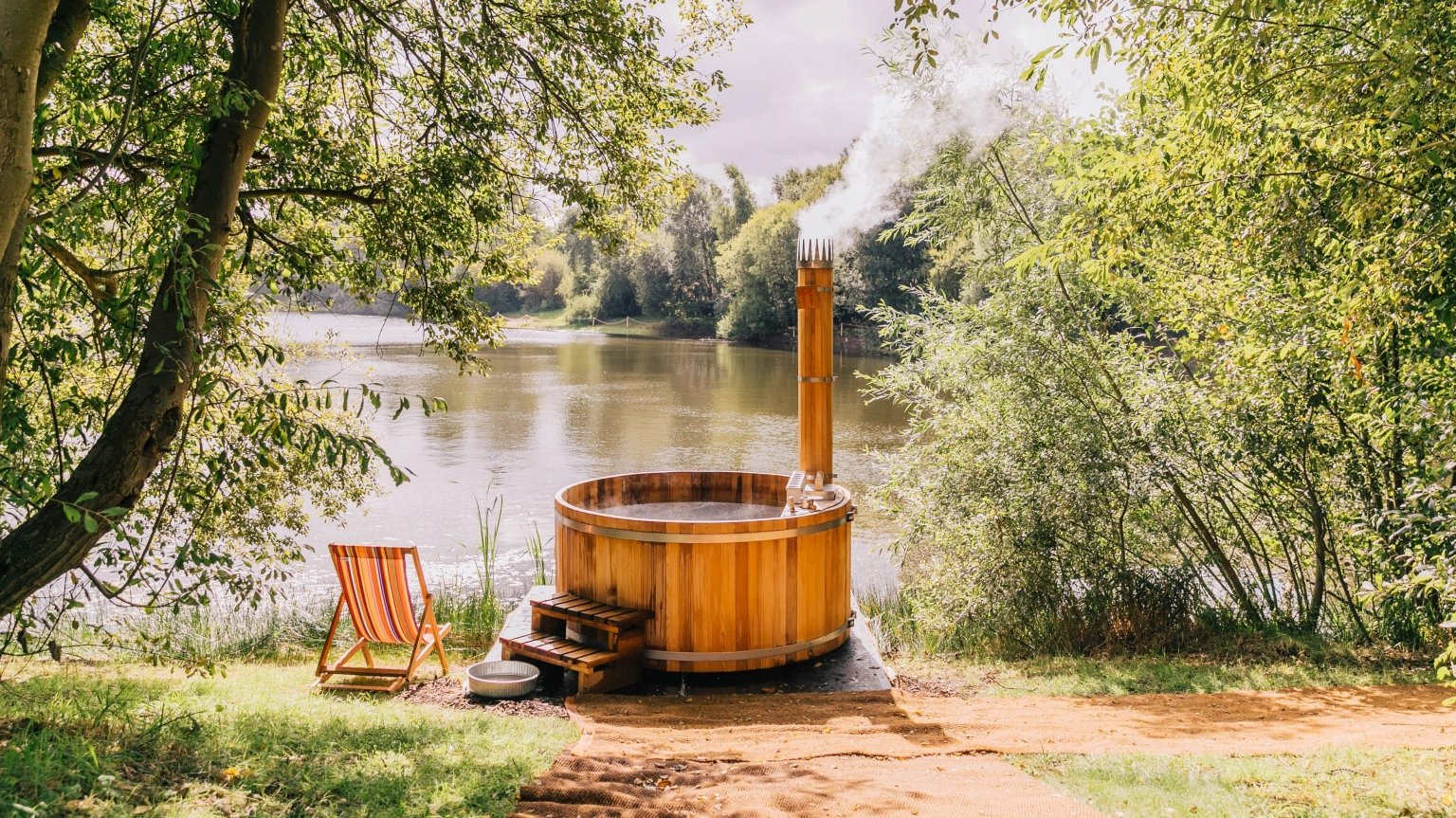 A photograph of a lakeside hot tub at the spa at Lost Village.