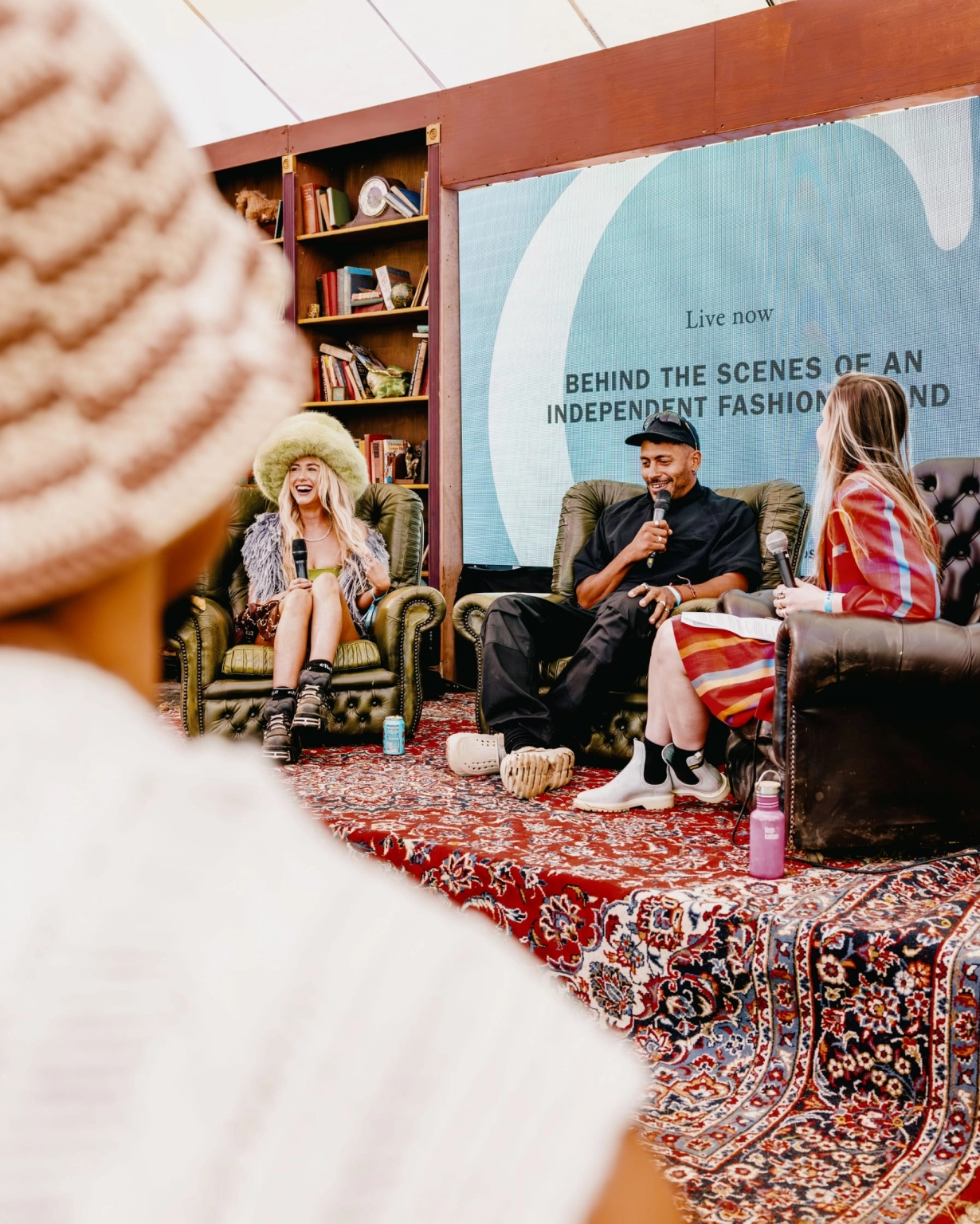 A photograph of three people delivering one of the talks at Lost Village.